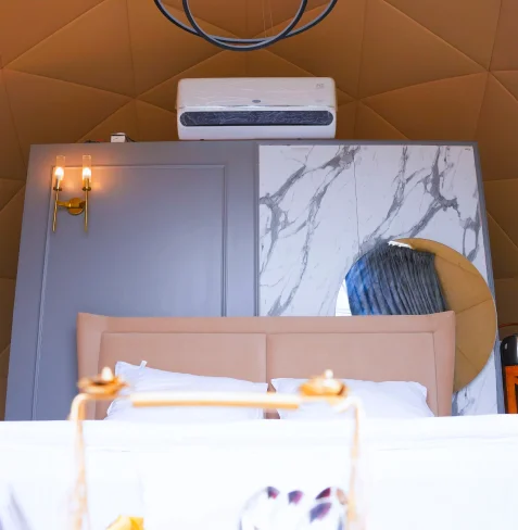 King bed and warm lighting inside dome