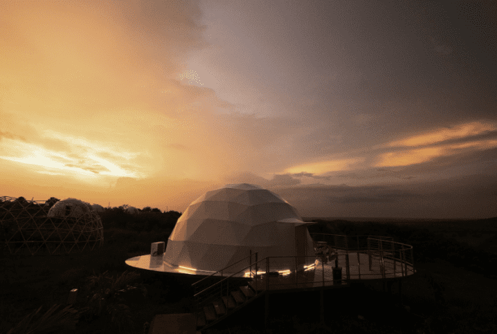 Domes silhouetted against glowing orange sunset